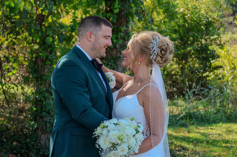 Bride and groom smiling together outdoors